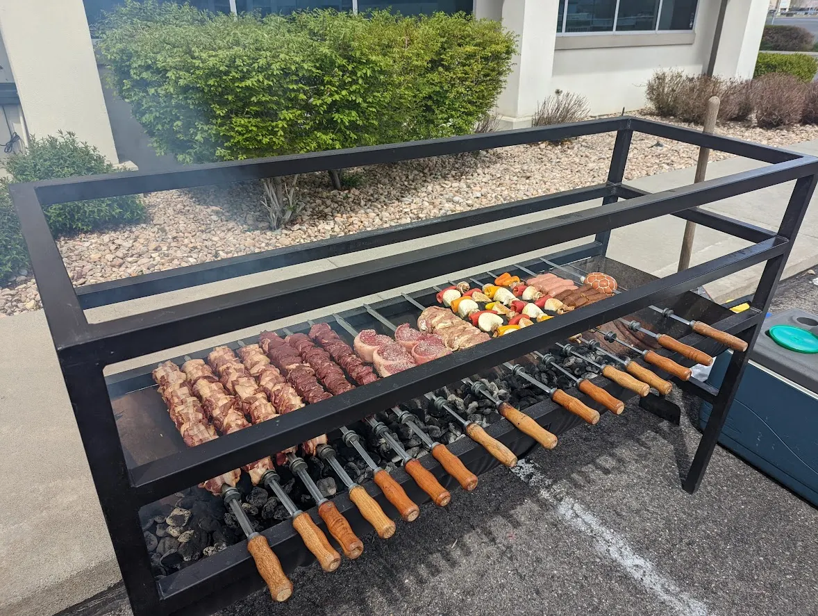 Brazilian churrasqueira grill with skewers over glowing coals